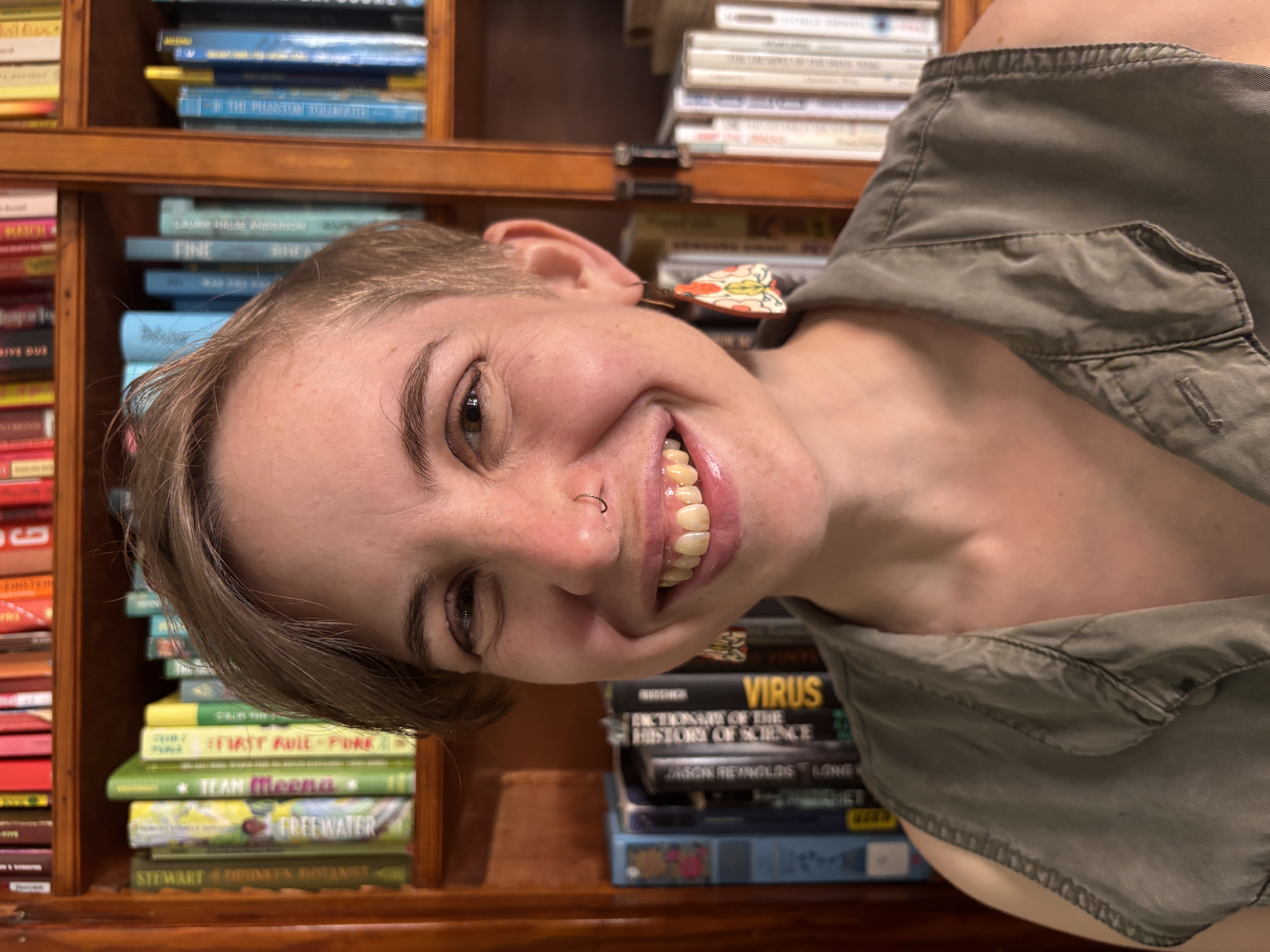 Mel smiling with books in the background